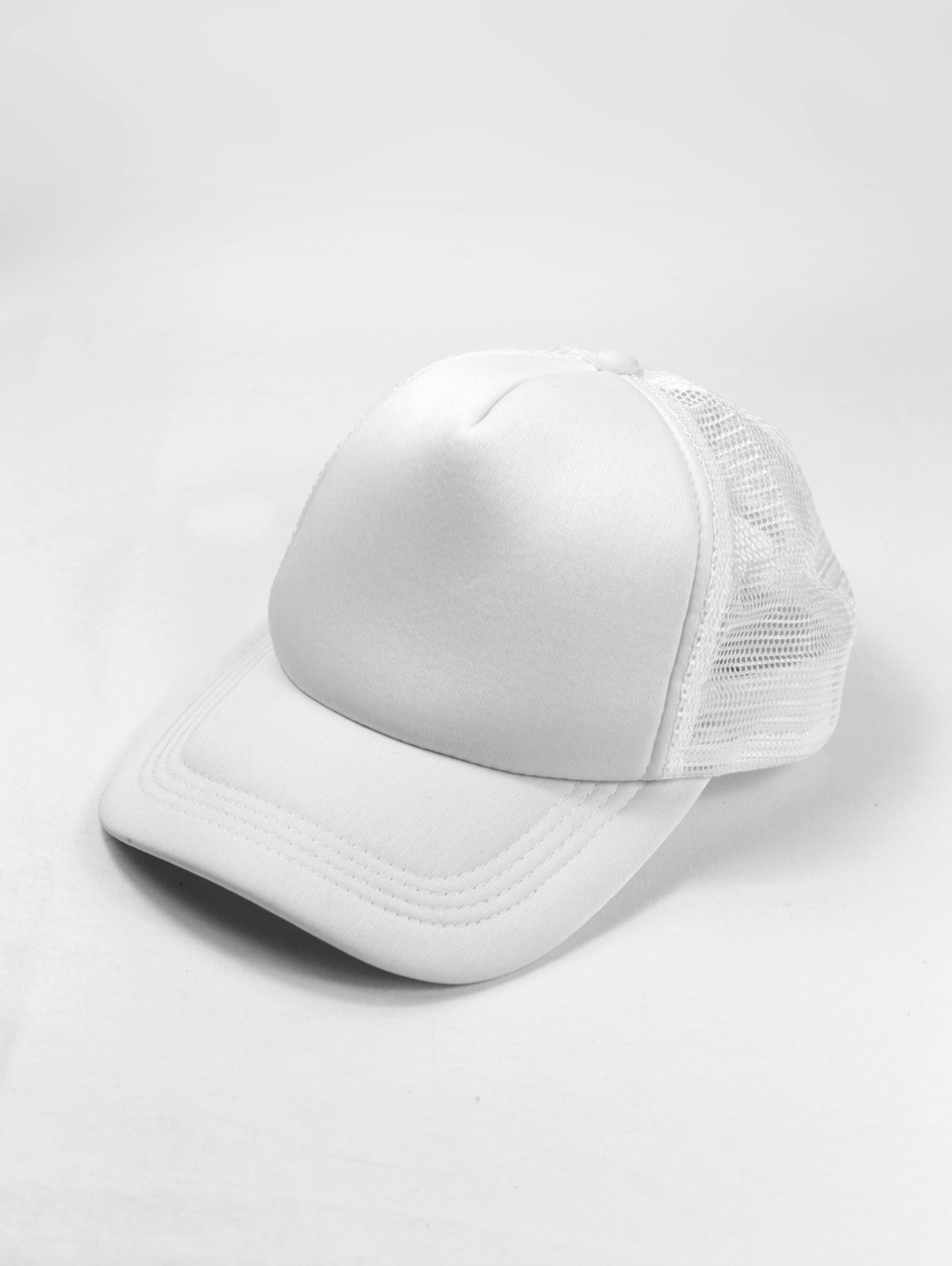 A white trucker cap on a white background.