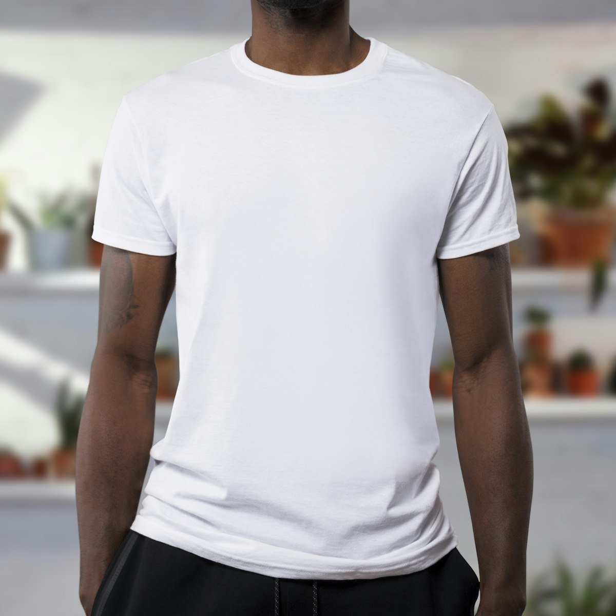 A person wearing a plain white t-shirt.